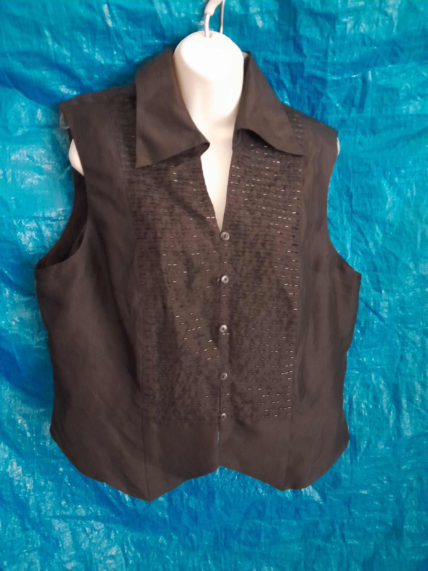 Black polyester vest with embedded small  beaded inset to front